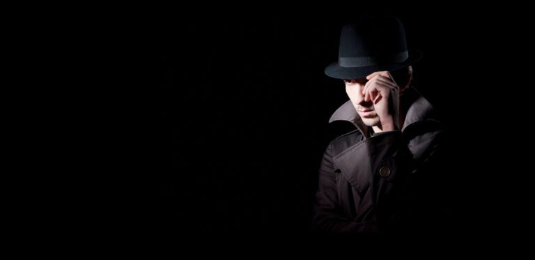 A man in a black hat and jacket.